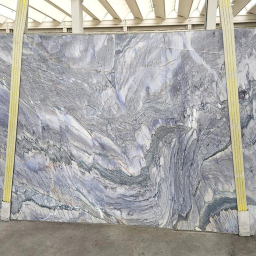 Deep Blue Sea quartziteplade — dyb blå og violet baggrund med hvide hvirvlende årer som havstrømme poleret finish